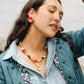 Noonday Mini Halo paprika earrings on model