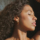 Canyon gold hoop earrings worn on the ear