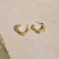 Canyon gold hoops on a stone surface