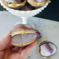Purple cowrie shell trinket box opened in hand
