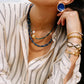 Noonday Halo deep indigo earrings, close up on model
