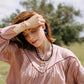 Noonday Halo deep indigo earrings on model