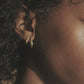 Siempre gold hoop earrings worn on the ear