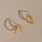 Siempre Earrings in gold, asymmetrical vine-shaped hoops, by Mountainside Jewelry