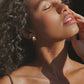 Close-up of Canyon gold hoops worn on the ear