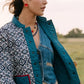 Noonday Mini Halo paprika earrings styled on model