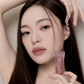 Model holding Objet Water 008 Pitch lip tint