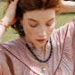 Noonday Halo deep indigo earrings styled on model